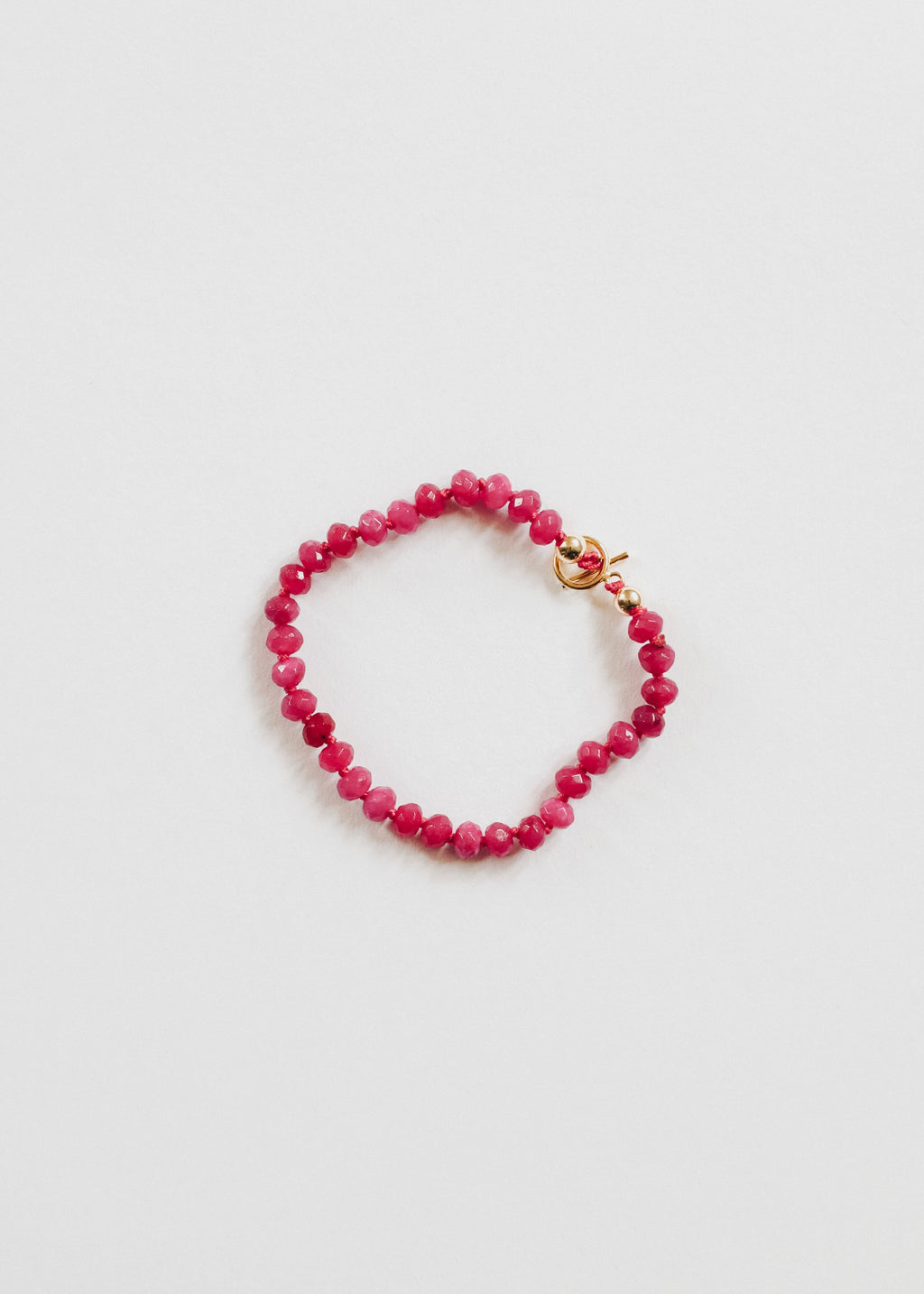 Pink beaded bracelet with 14k gold-filled accents and a toggle closure.