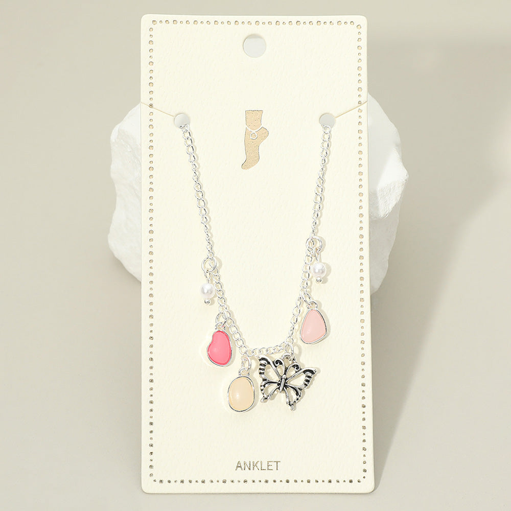 Silver-tone butterfly charm anklet with pink teardrop accents and pale round beads.