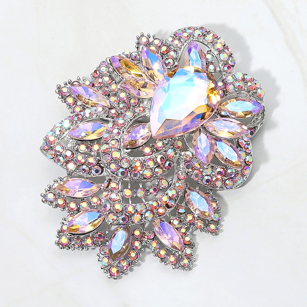 Pink and iridescent rhinestone flower brooch with a silver-tone finish.