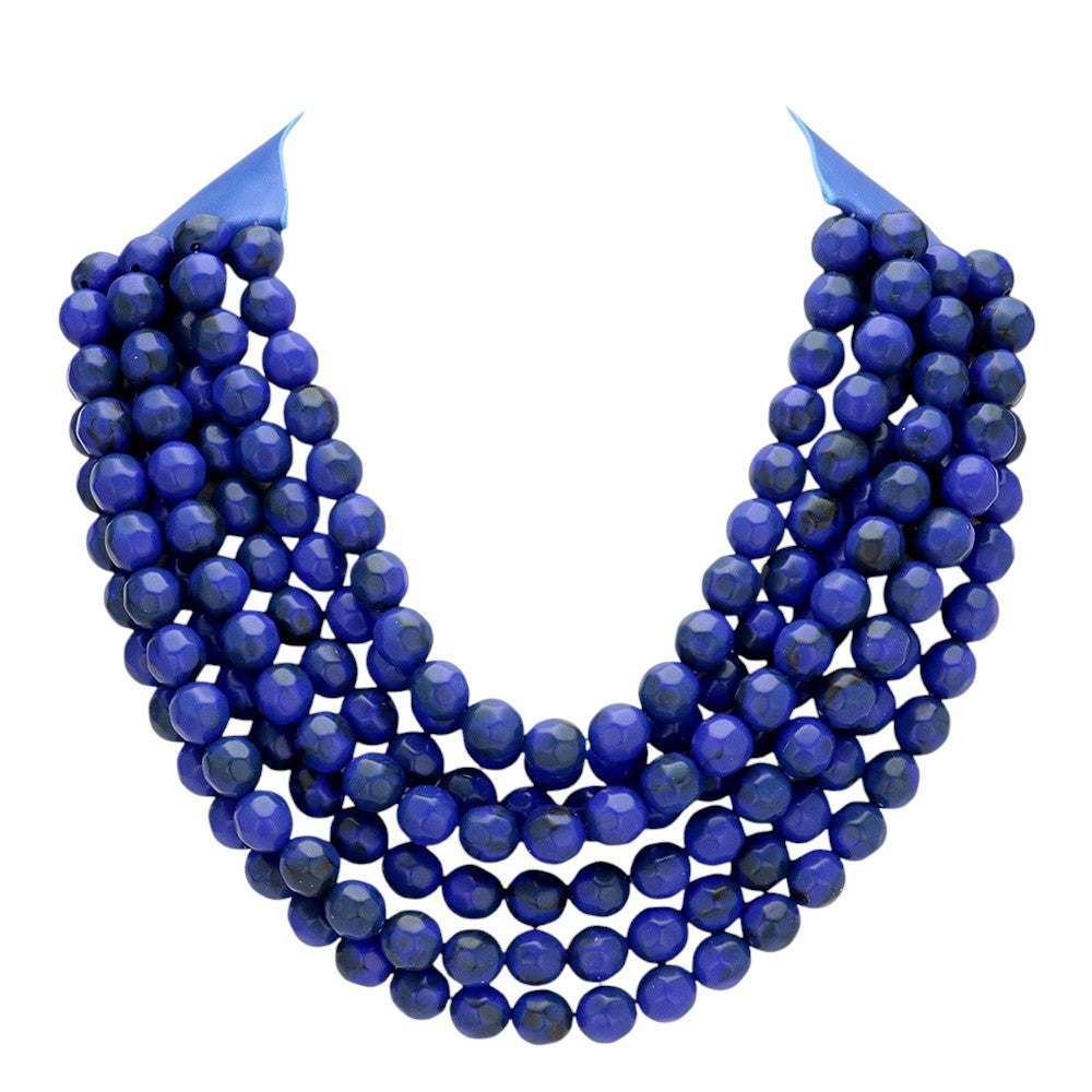 Chunky multi-strand beaded statement necklace shown in an additional colorway on a display form