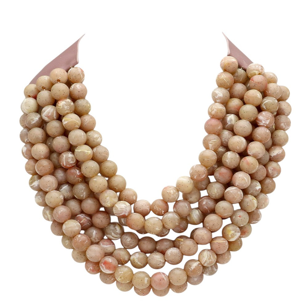 Chunky multi-strand beaded statement necklace shown in an additional colorway on a display form