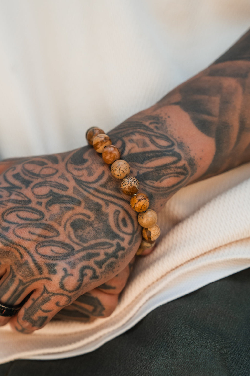 Desert Storm Gemstone GOLD Ed. Bracelet: brown marbled round beads with decorative gold-tone clasp, beads worn on a wrist.