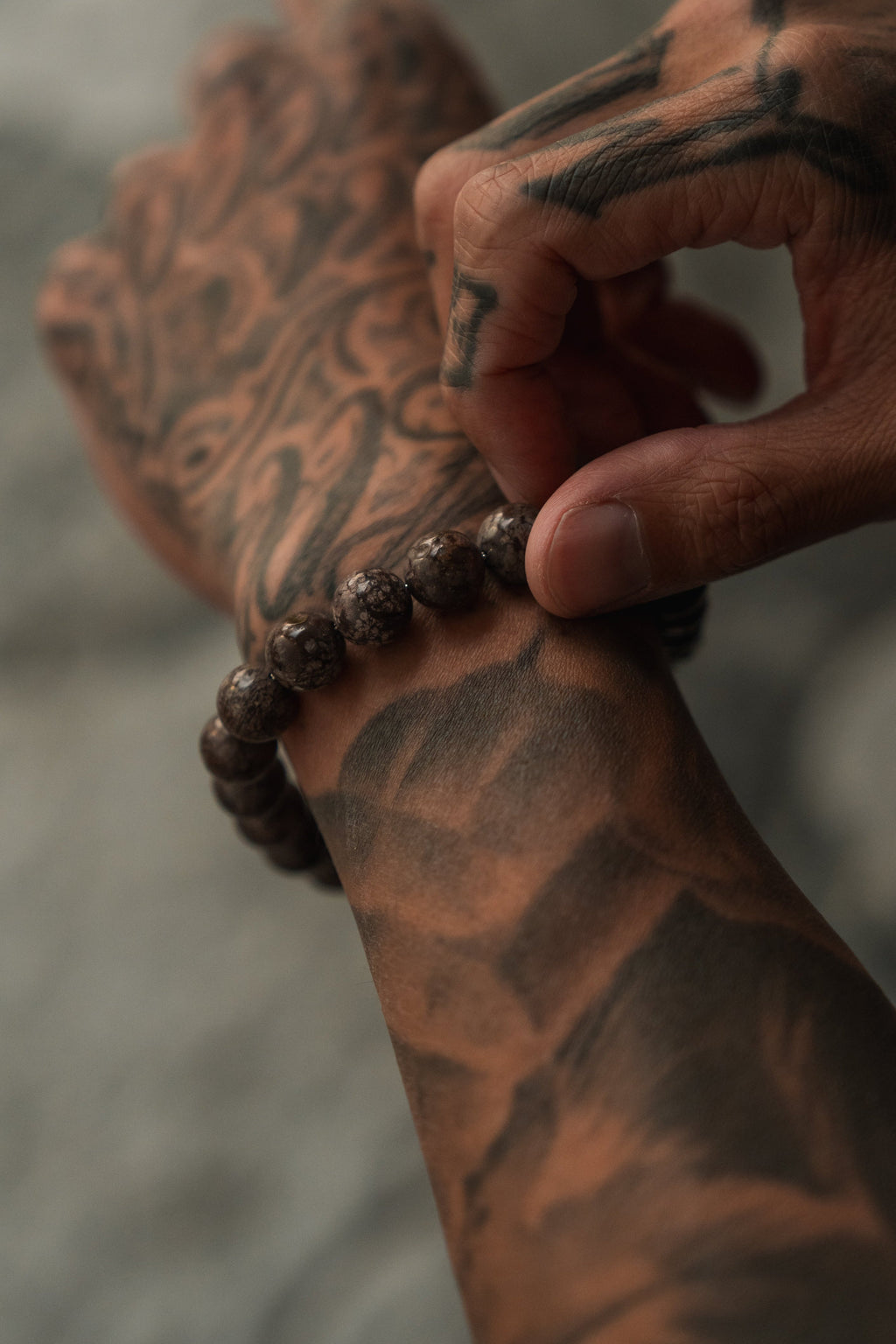 The Black Seal Bracelet: brown speckled round beads with decorative silver-tone clasp, beads worn on a wrist.