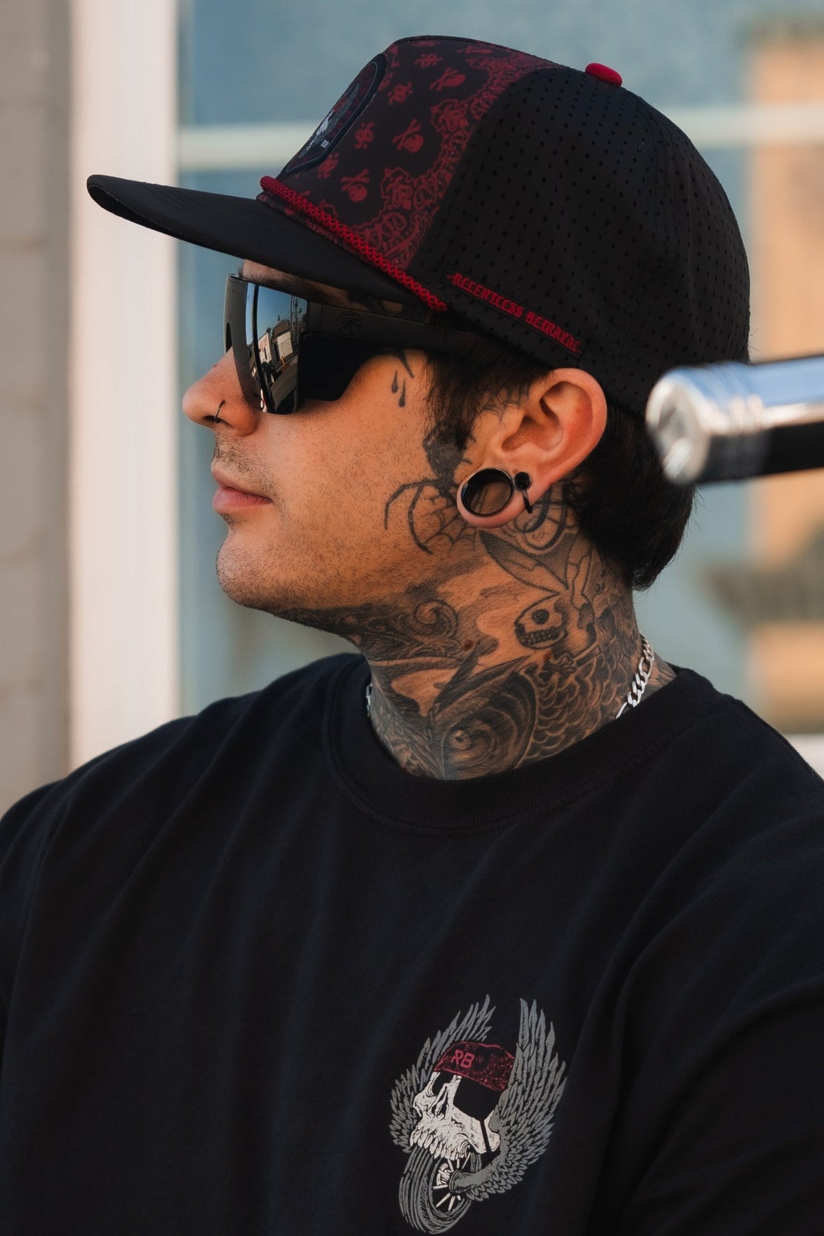 All Gas No Brakes Premium Snapback: black cap with red bandana-style print, skull patch and red rope trim, side view on a model.