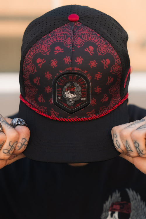 All Gas No Brakes Premium Snapback: black cap with red bandana-style print, skull patch and red rope trim, front view on a model.