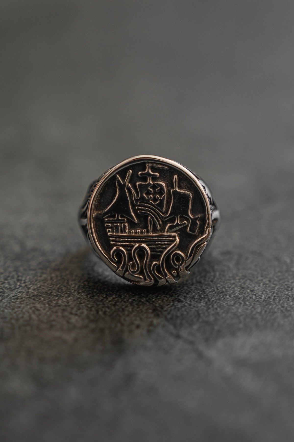 The Rise of the Kraken Ring: round signet face with a sailing ship and curling tentacles, front product view.