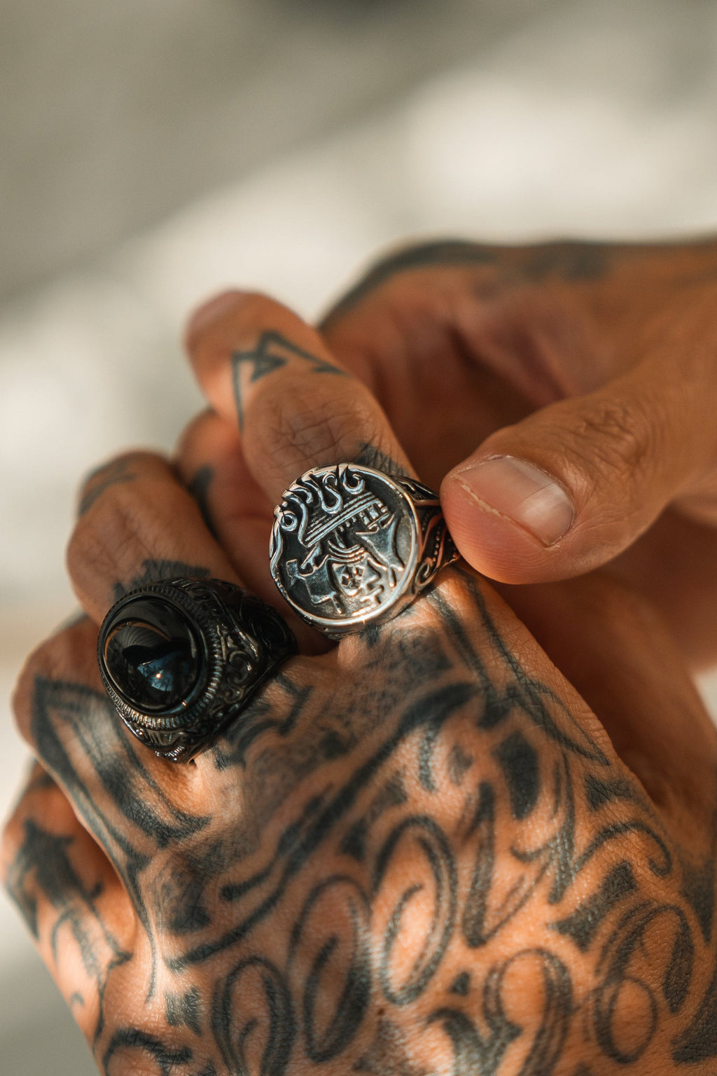 The Rise of the Kraken Ring: round signet face with a sailing ship and curling tentacles, worn beside another ring.