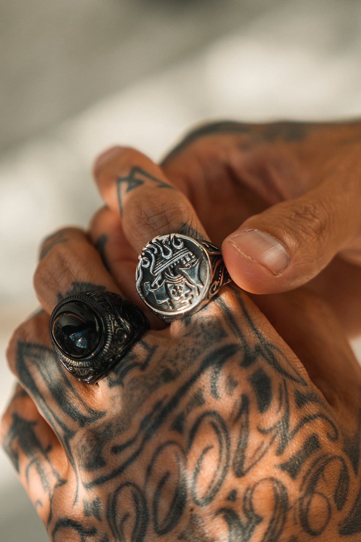 The Rise of the Kraken Ring: round signet face with a sailing ship and curling tentacles, worn beside another ring.