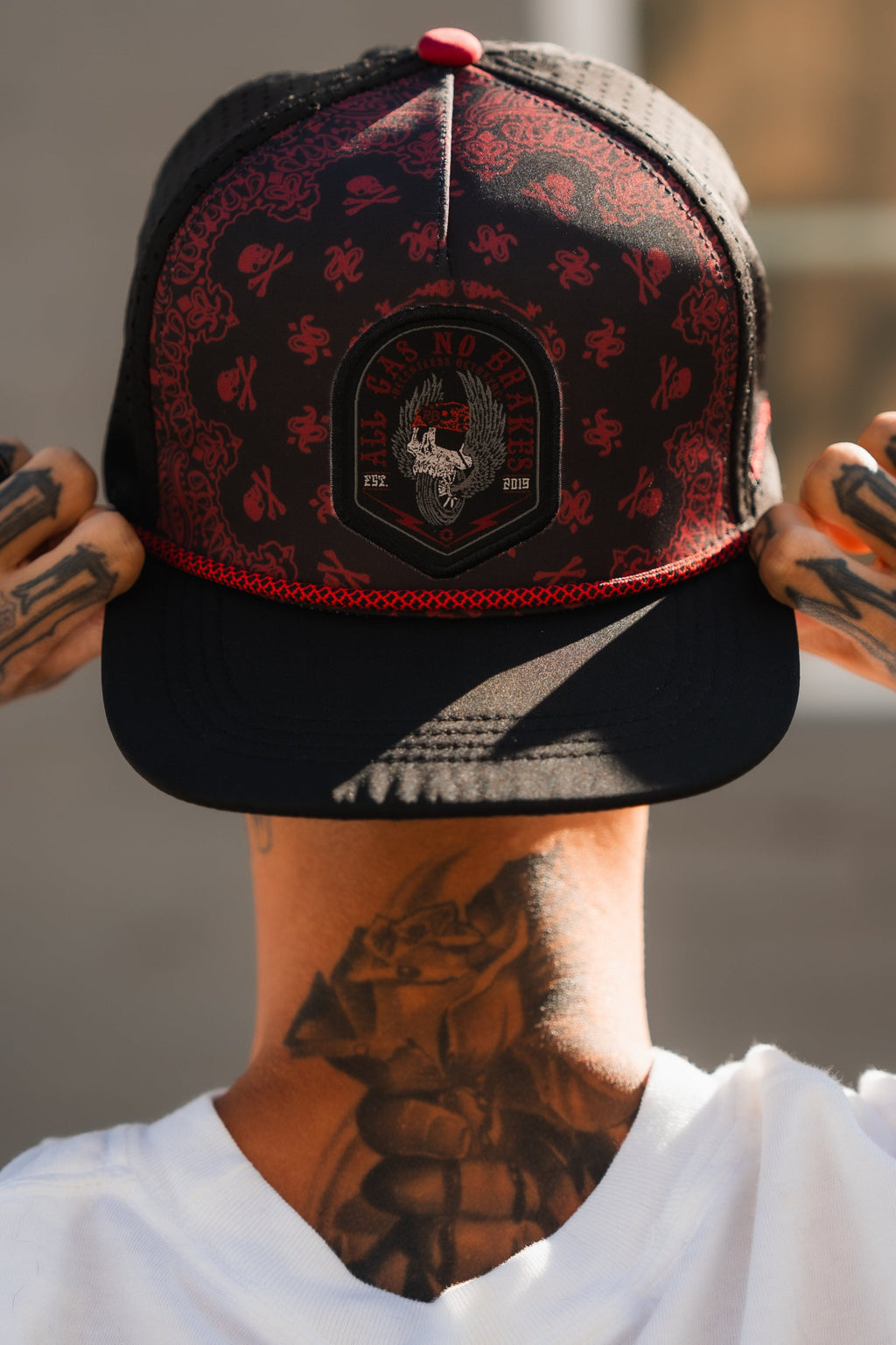 All Gas No Brakes Premium Snapback: black cap with red bandana-style print, skull patch and red rope trim, worn backward.
