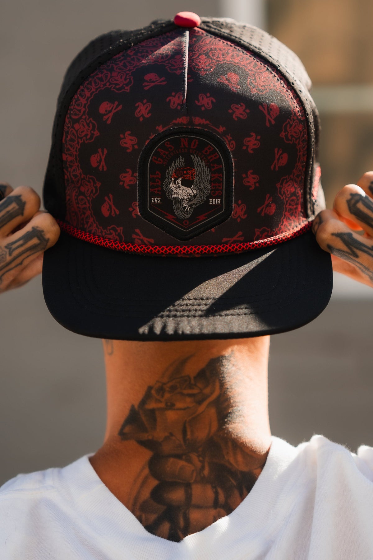 All Gas No Brakes Premium Snapback: black cap with red bandana-style print, skull patch and red rope trim, worn backward.