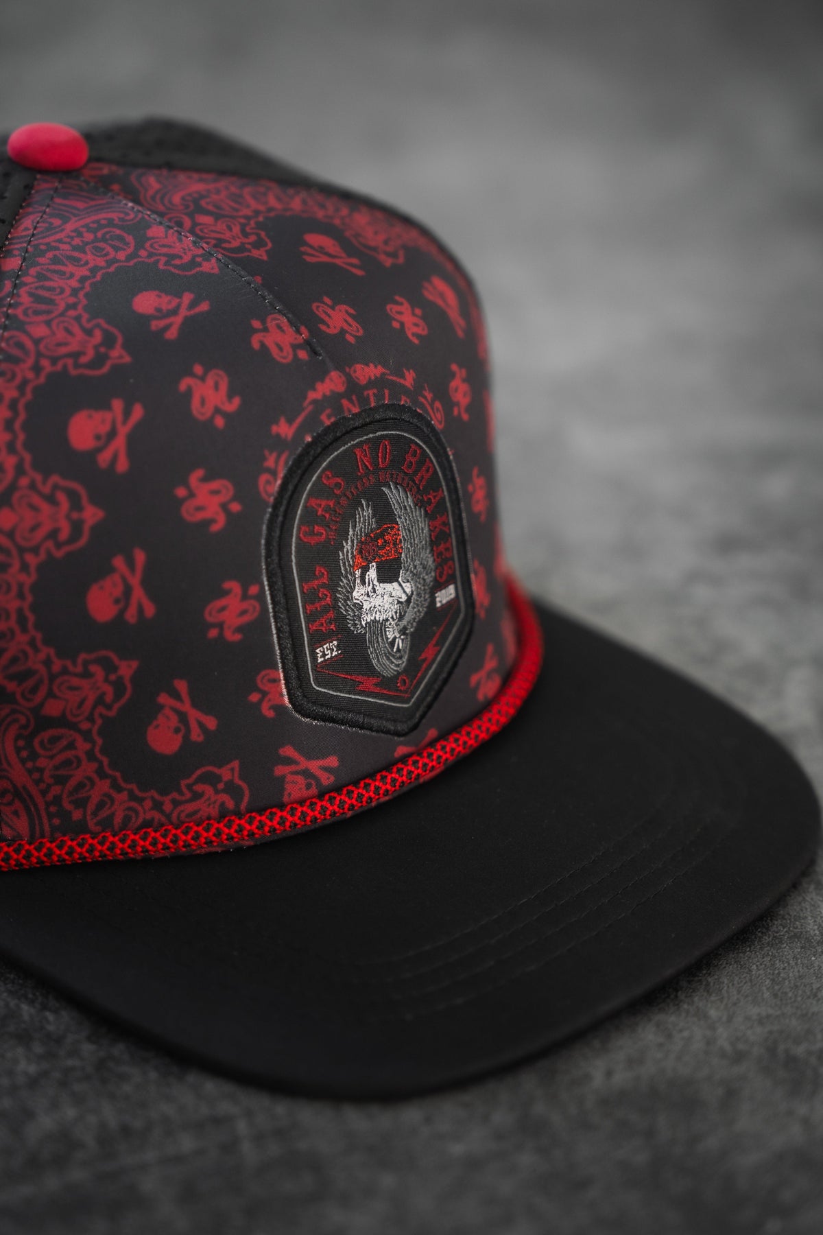All Gas No Brakes Premium Snapback: black cap with red bandana-style print, skull patch and red rope trim, angled front detail.
