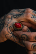Burning Rose Ring: oval red center, gold-tone border and detailed silver-tone band, worn on a hand.