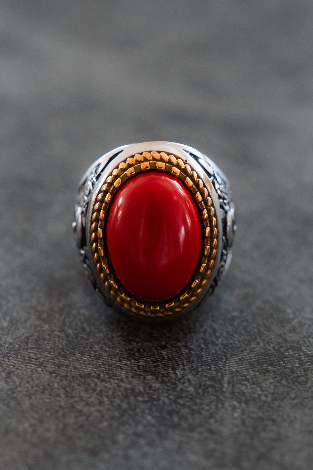 Burning Rose Ring: oval red center, gold-tone border and detailed silver-tone band, front product view.