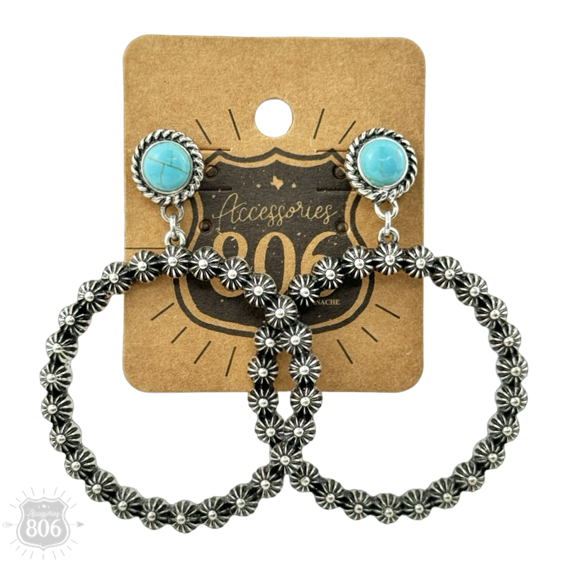 Blue colorway concho berry stud earrings with a turquoise-color stone stud and silver-tone floral-textured bead hoop, shown on a hang tag