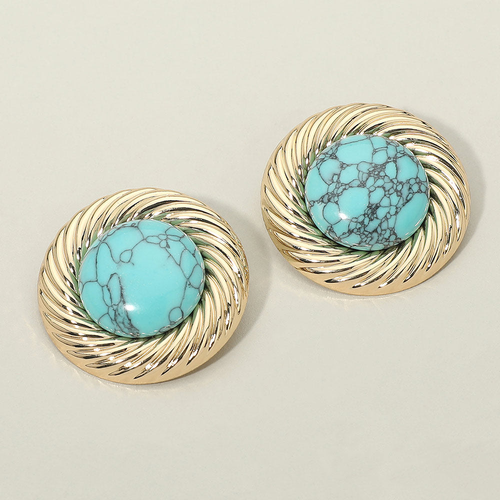 Gold-tone stud earrings with a round turquoise-color stone center framed by a textured swirl rim