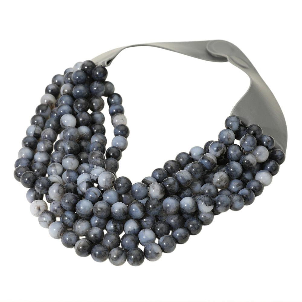 Chunky multi-strand beaded statement necklace shown in an additional colorway on a display form