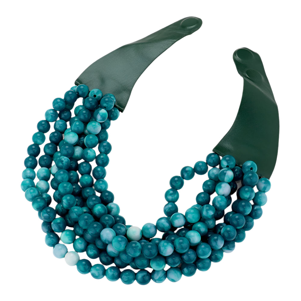 Chunky multi-strand beaded statement necklace shown in an additional colorway on a display form