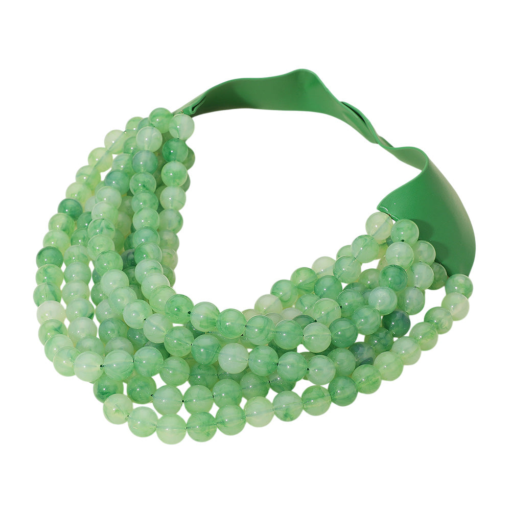 Chunky multi-strand beaded statement necklace shown in an additional colorway on a display form