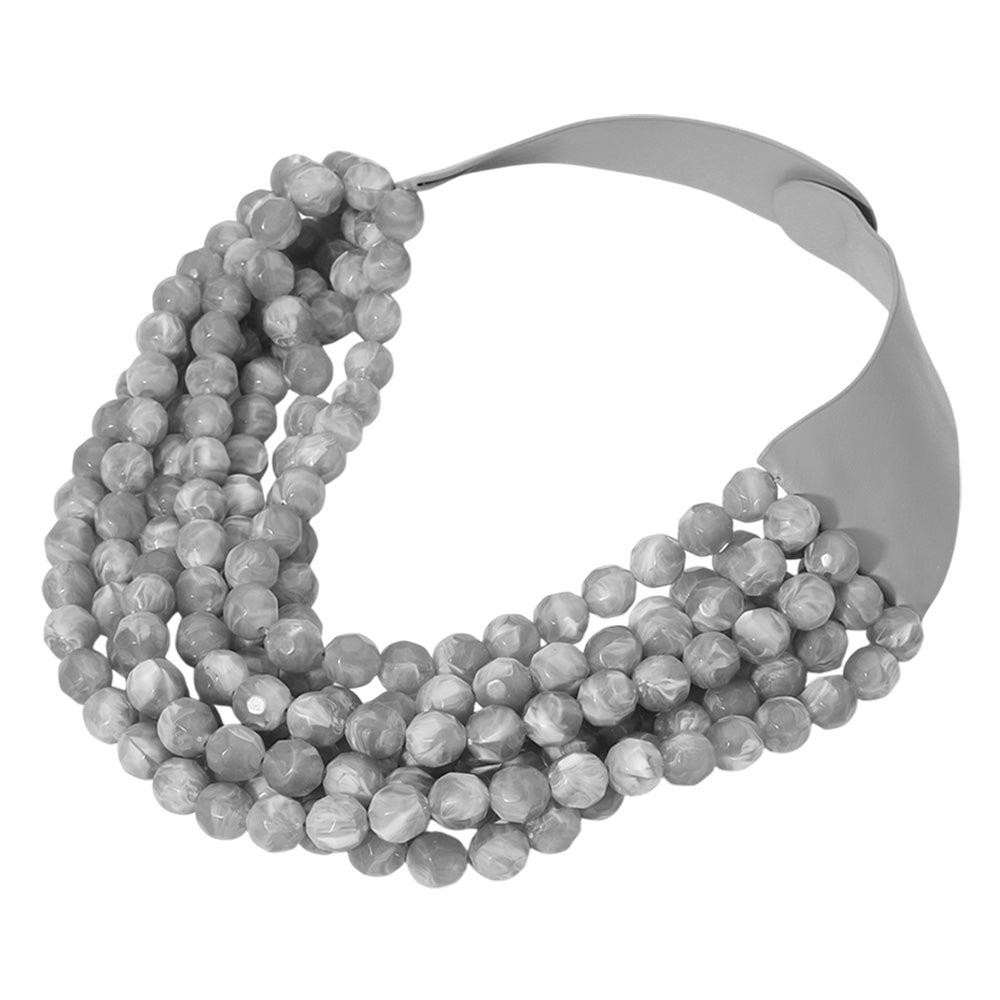 Chunky multi-strand beaded statement necklace shown in an additional colorway on a display form