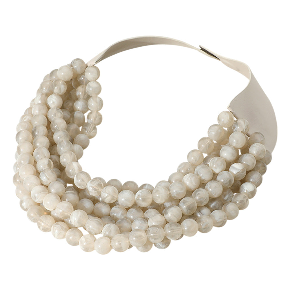 Chunky multi-strand beaded statement necklace shown in an additional colorway on a display form