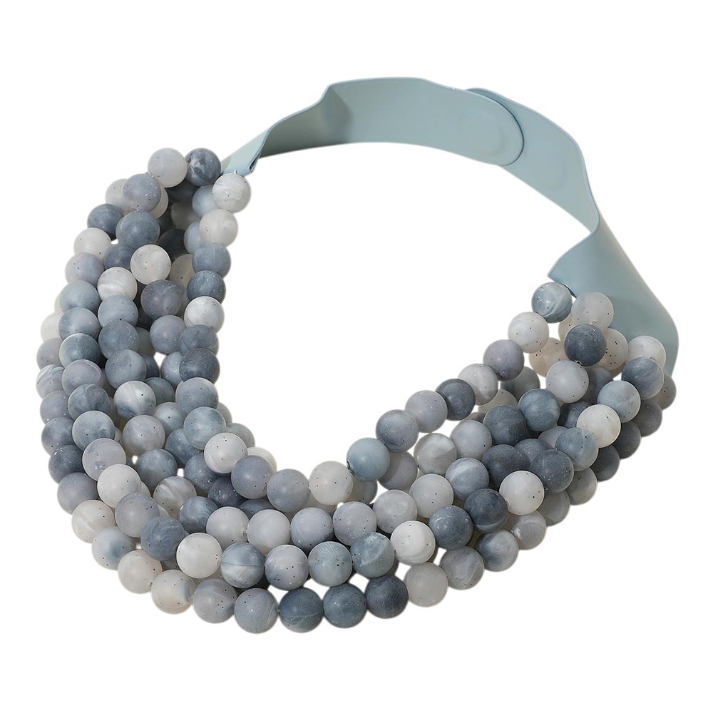 Chunky multi-strand beaded statement necklace shown in an additional colorway on a display form