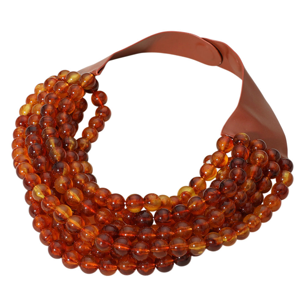 Chunky multi-strand beaded statement necklace shown in an additional colorway on a display form