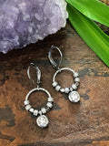 Halo Shimmer Rhinestone Earrings displayed on wood