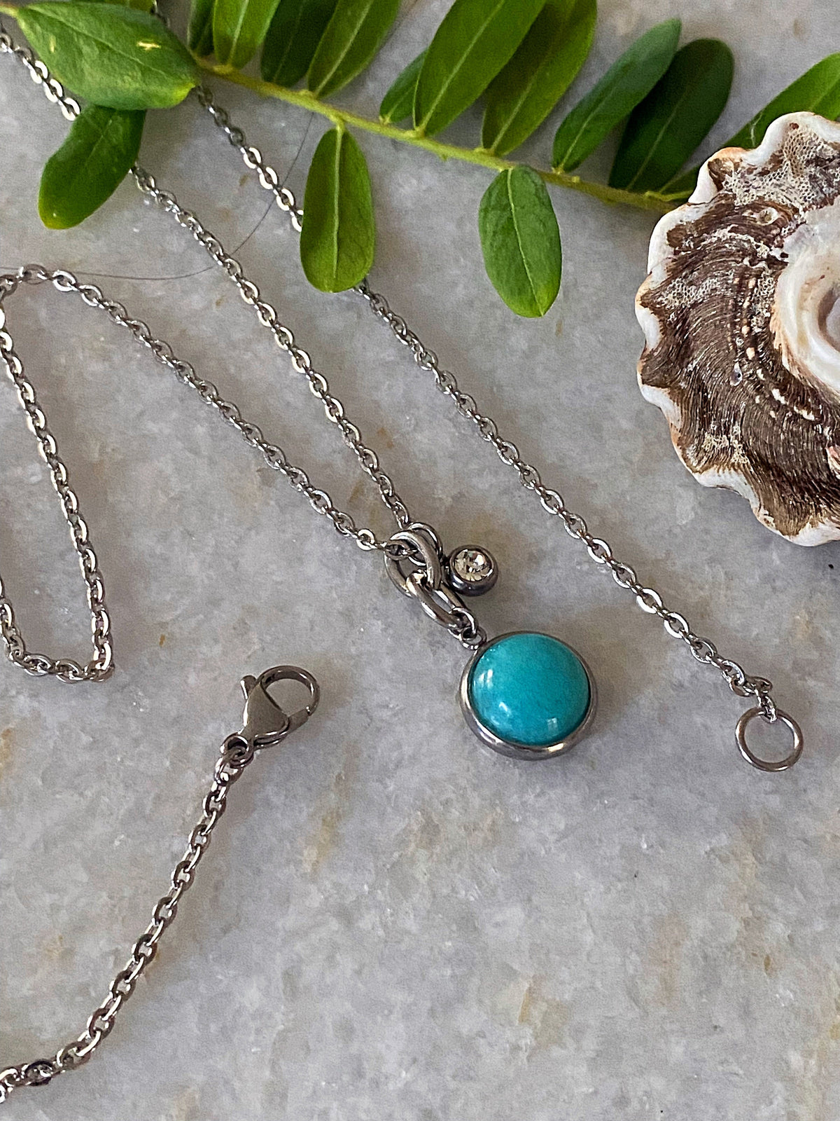 Additional product photo of the Layered Stone Charm Necklace showing the round stone pendant on a fine chain