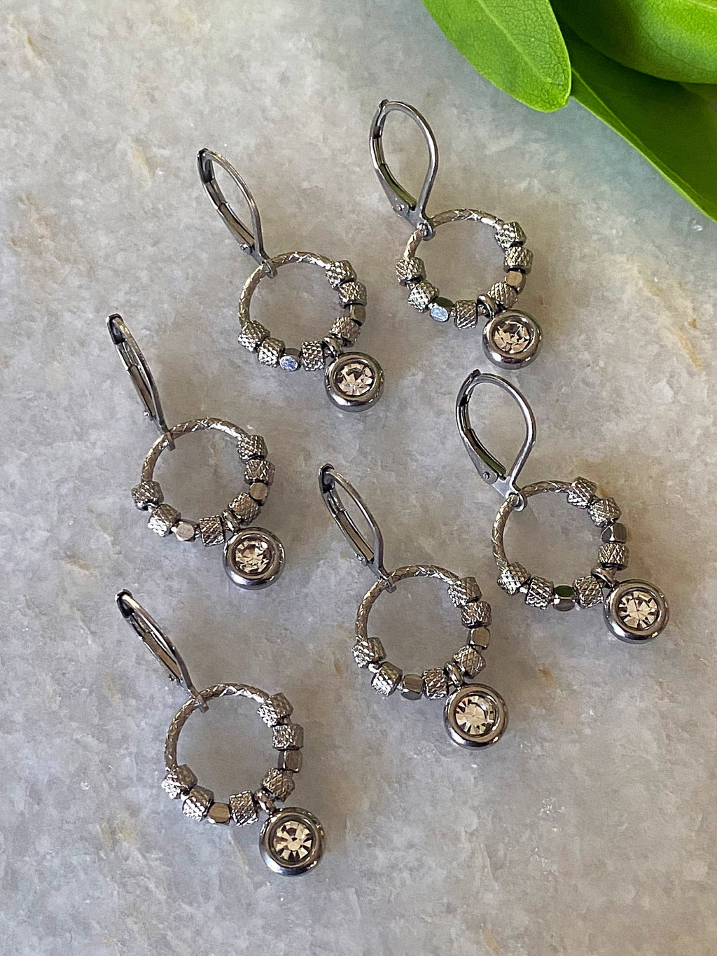 Halo Shimmer Rhinestone Earrings displayed on fabric