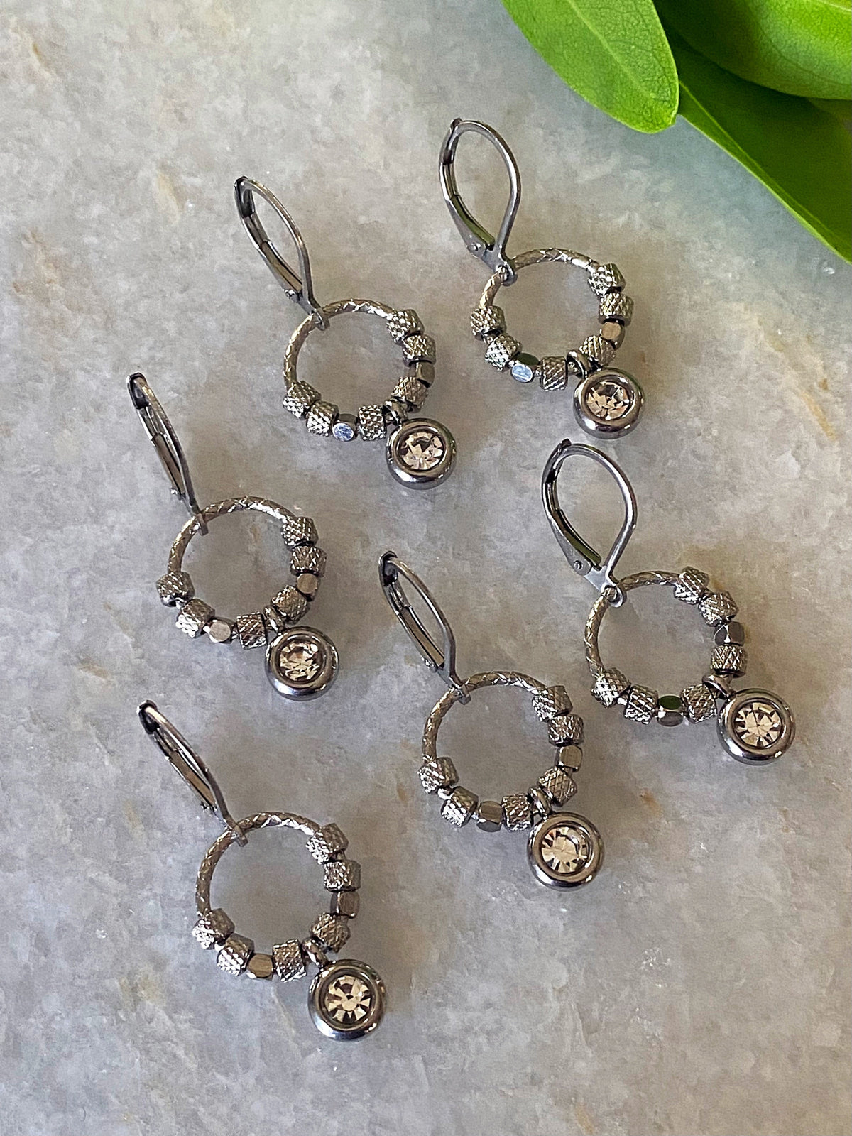 Halo Shimmer Rhinestone Earrings displayed on fabric