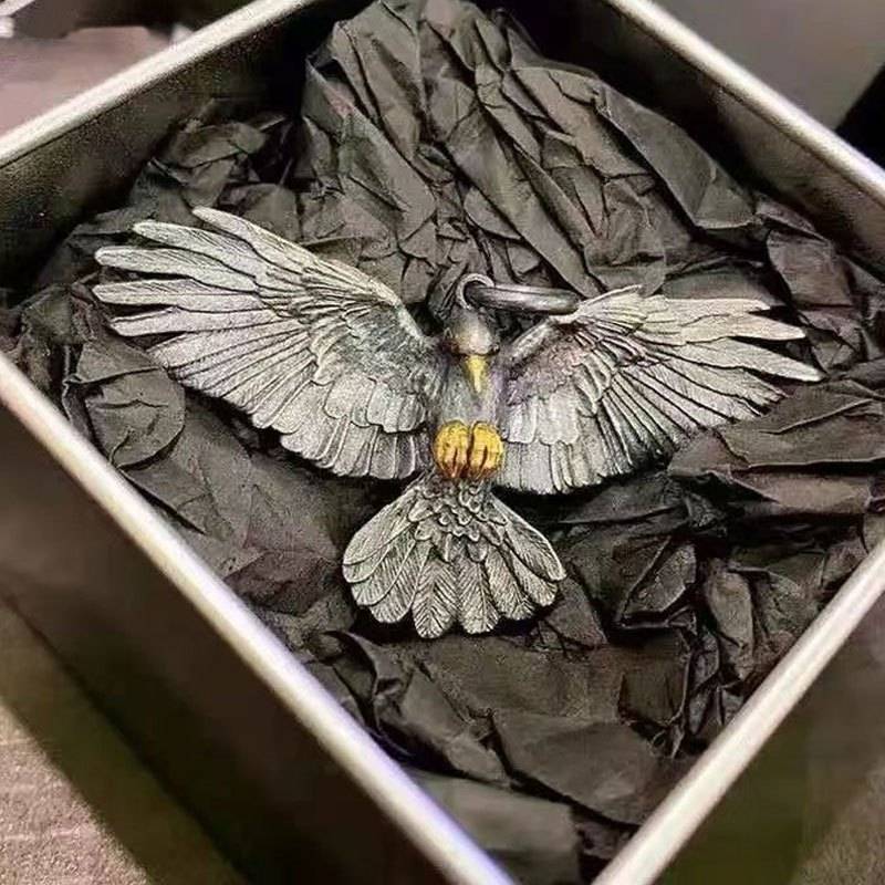 Falcon pendant with gold-tone beak and talon accents displayed alone in a gift box