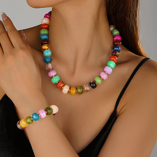 Model wearing the Chunky Beaded Necklace & Bracelet Set, showing the multicolor marbled acrylic beads on the neck and wrist