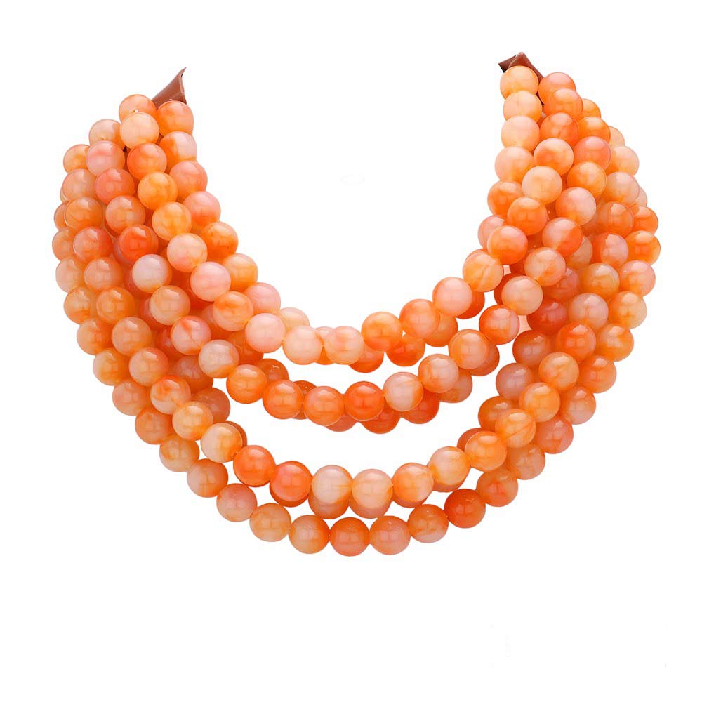 Chunky multi-strand beaded statement necklace shown in an additional colorway on a display form