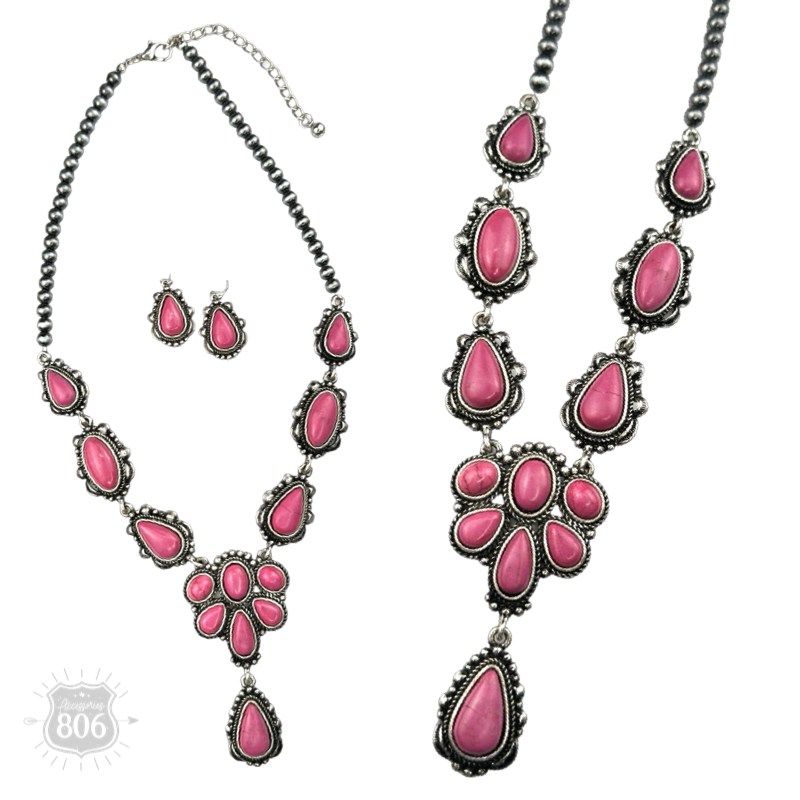Close-up of the fuchsia-pink concho necklace's stone cluster pendant and matching drop earrings
