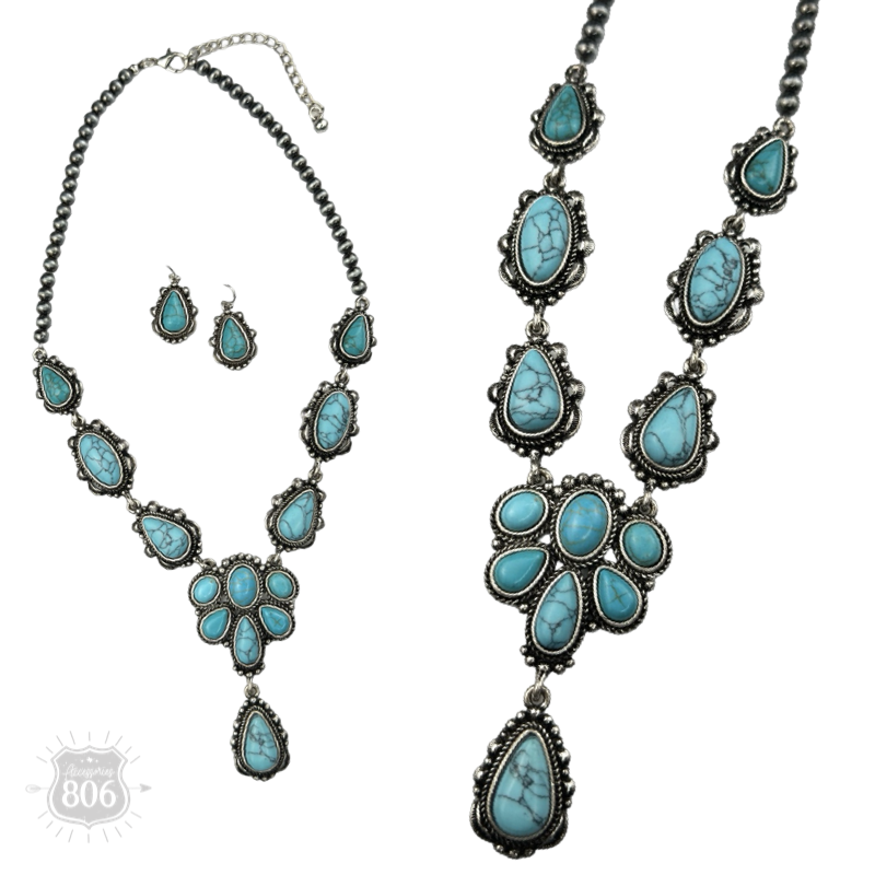 Close-up of the turquoise-color concho necklace's stone cluster pendant and matching drop earrings