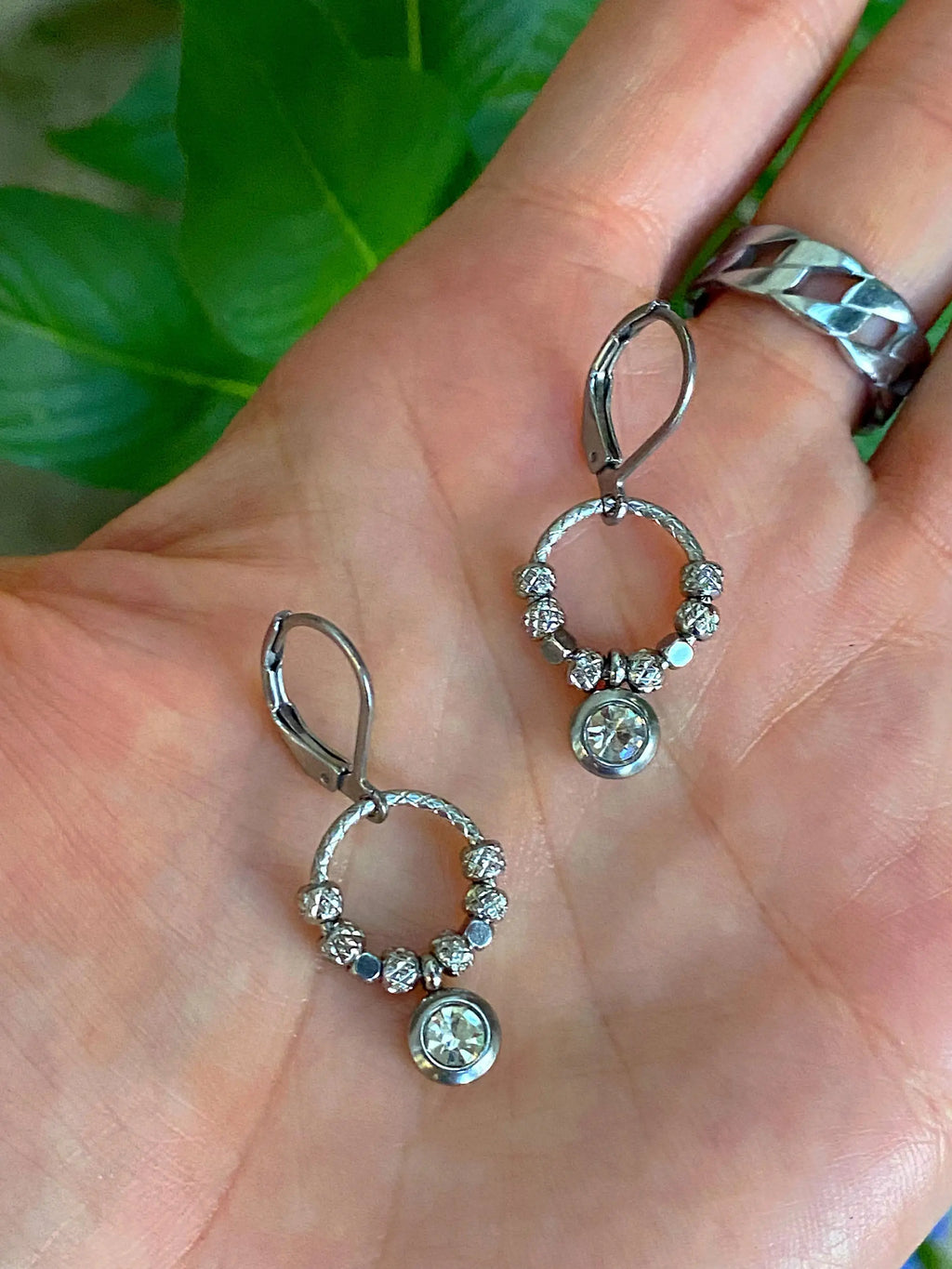 Halo Shimmer Rhinestone Earrings displayed in a hand