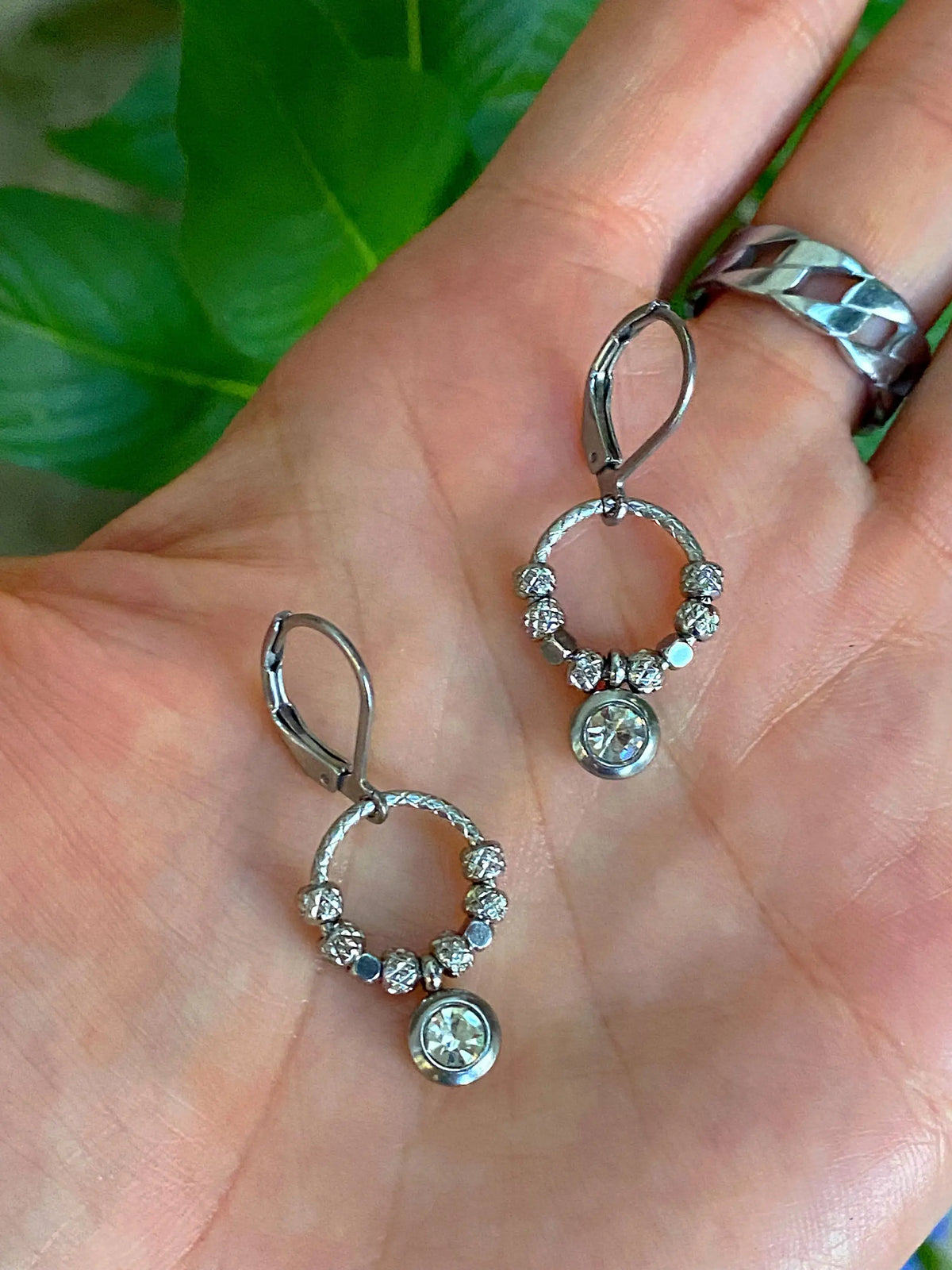 Halo Shimmer Rhinestone Earrings displayed in a hand