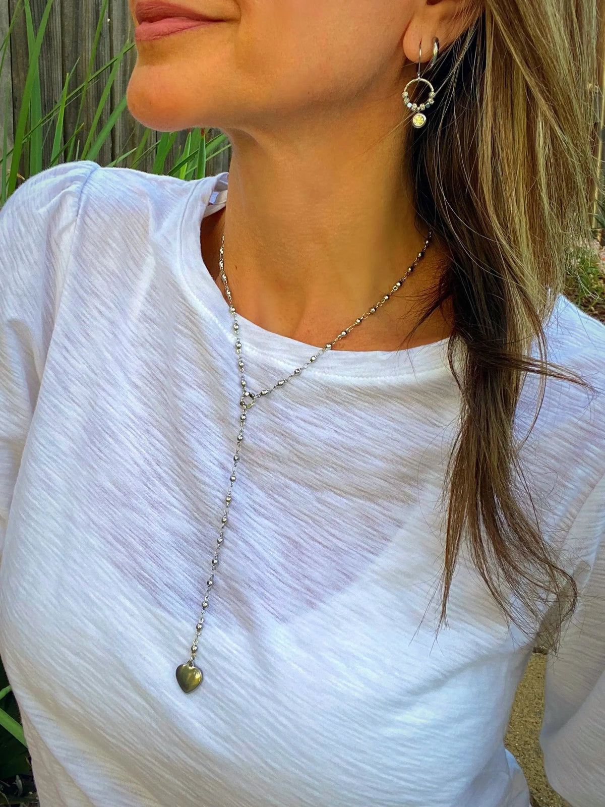 Halo Shimmer Rhinestone Earrings worn with a white top